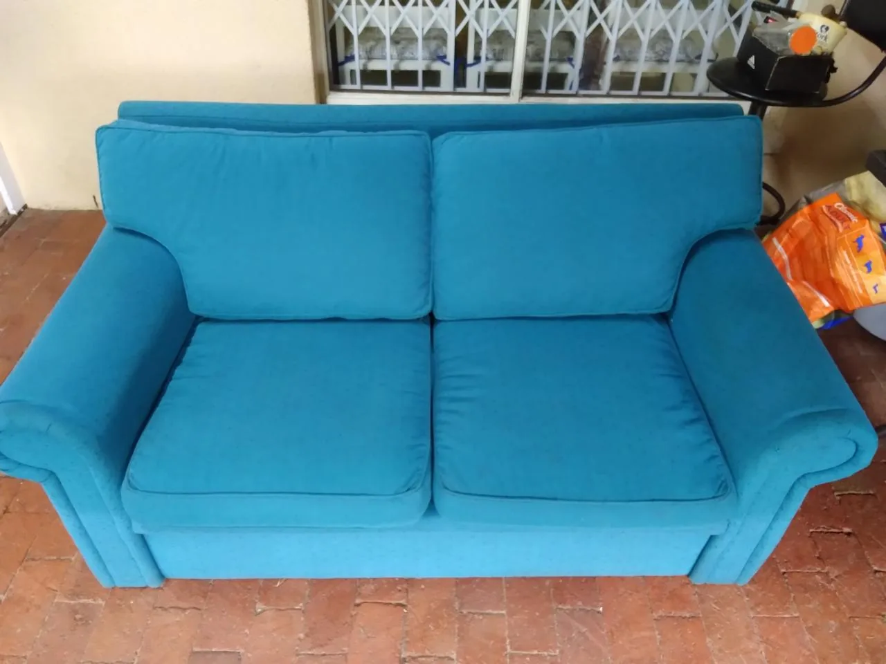 Blue upholstered couch after cleaning